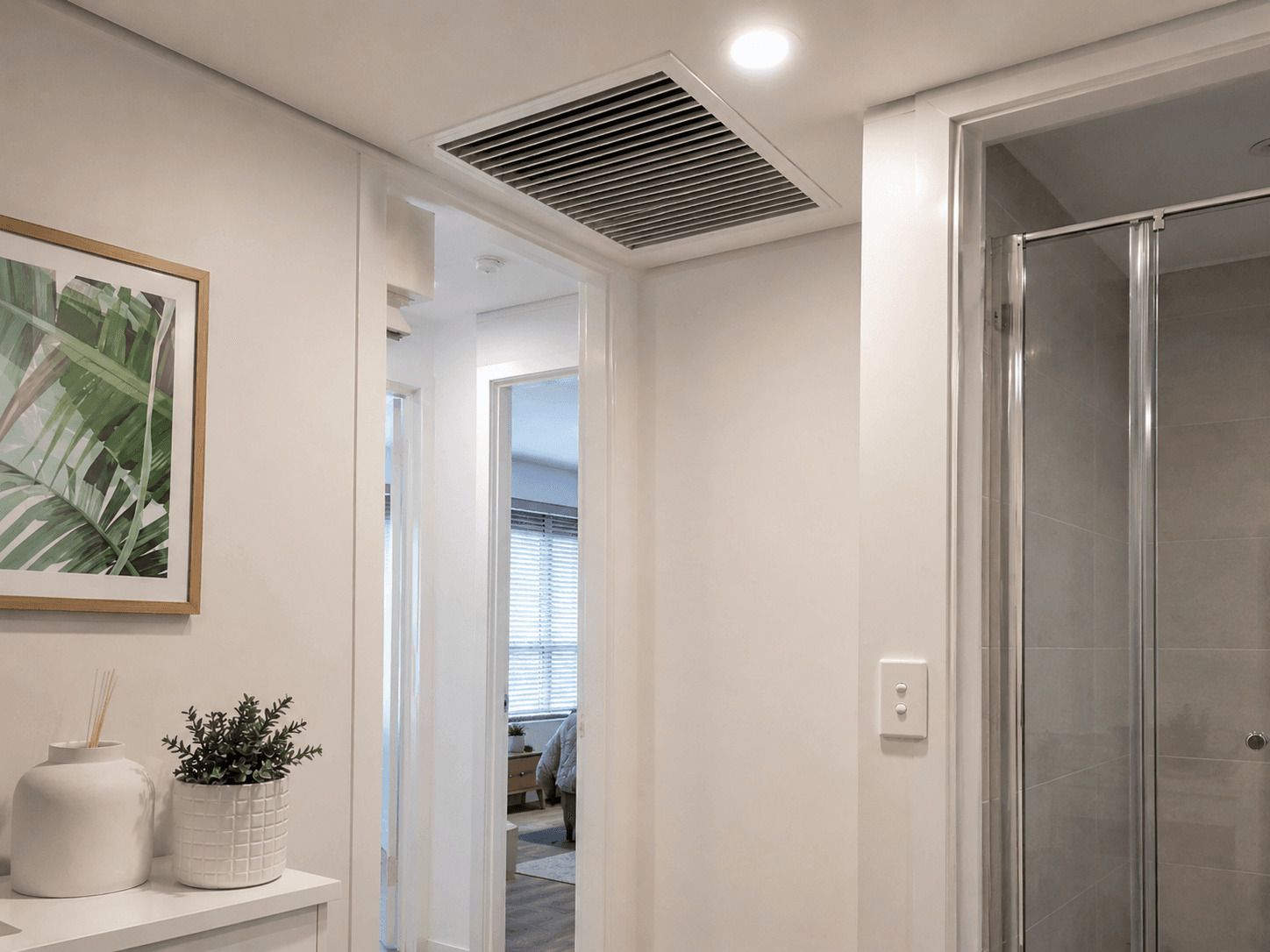 A newly serviced ceiling air conditioning vent in a hallway