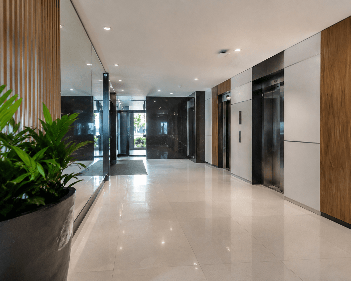 Immaculately maintained apartment building lobby with lift entries and polished floors